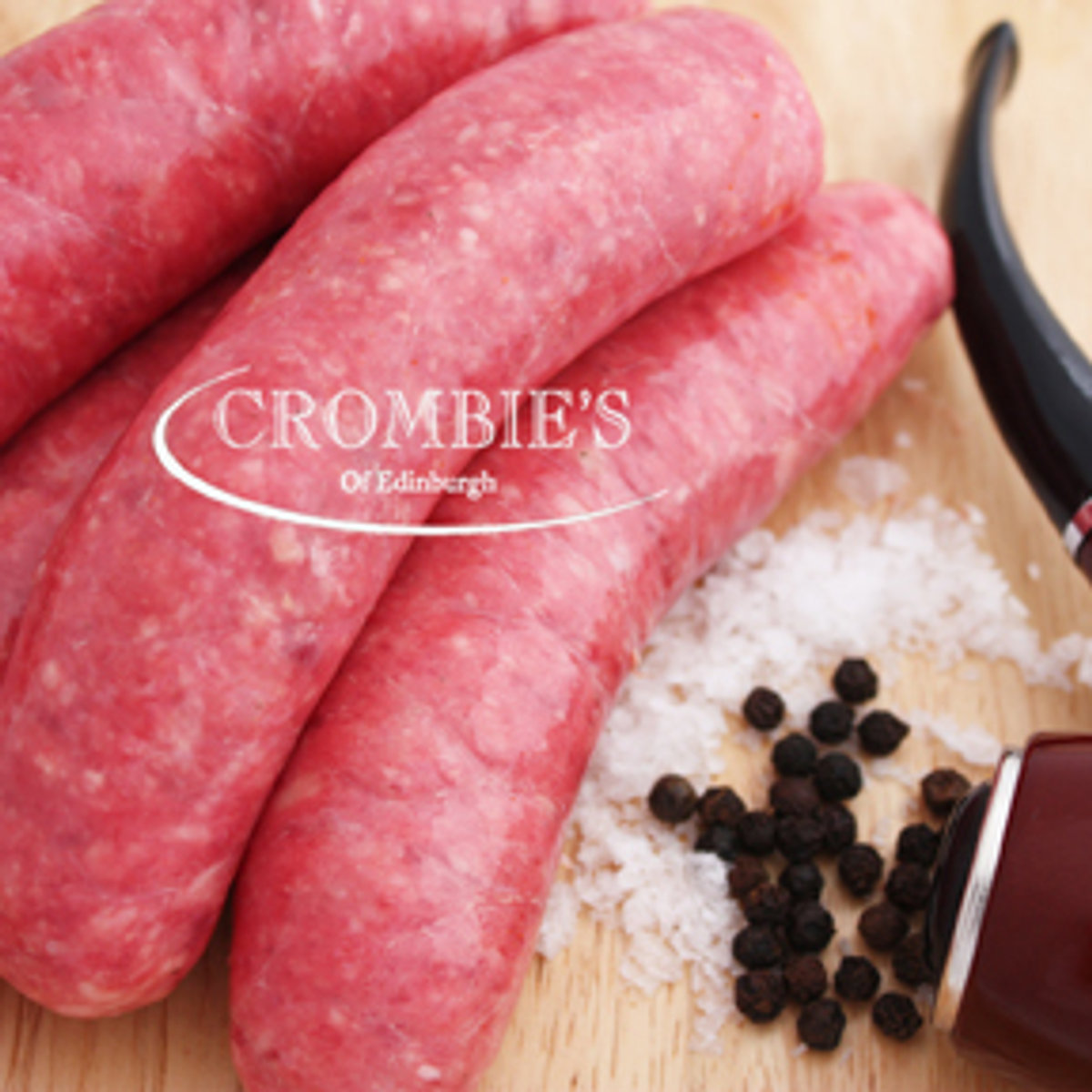 Raw beef sausages, deep red, with sea salt and black peppercorns