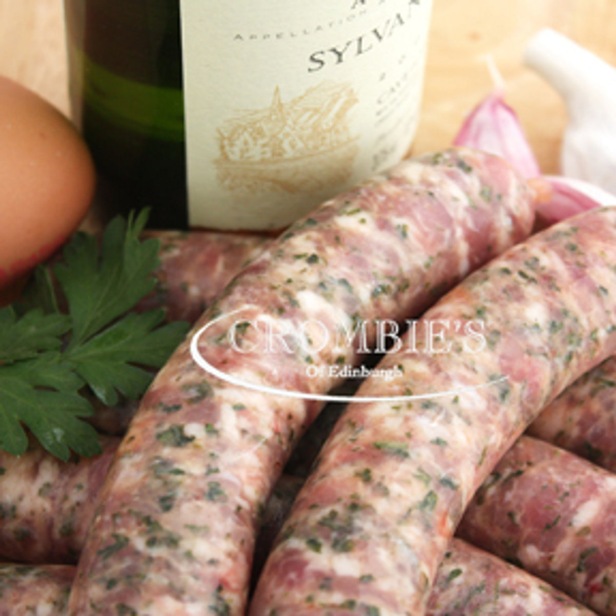Fresh white pork and herb sausages scattered with parsley
