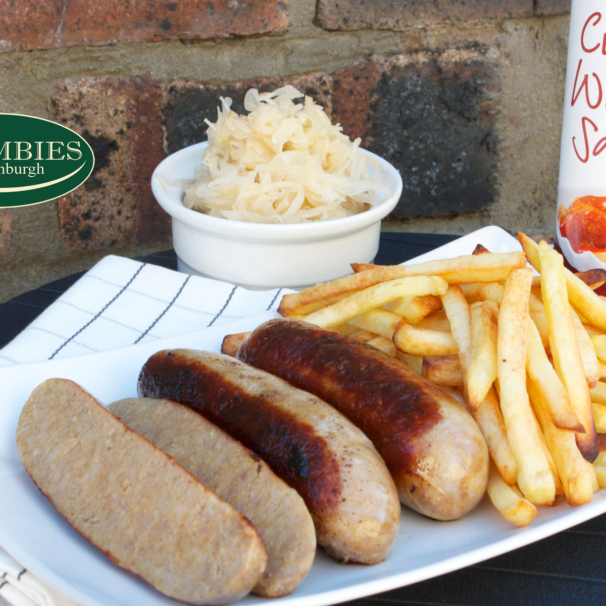 Cooked sausages served with fries and sauerkraut