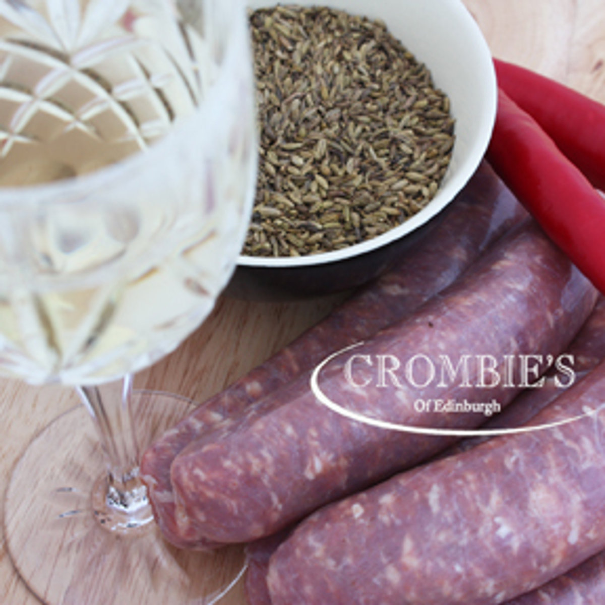Dark speciality sausages with fennel seeds and a glass of white wine