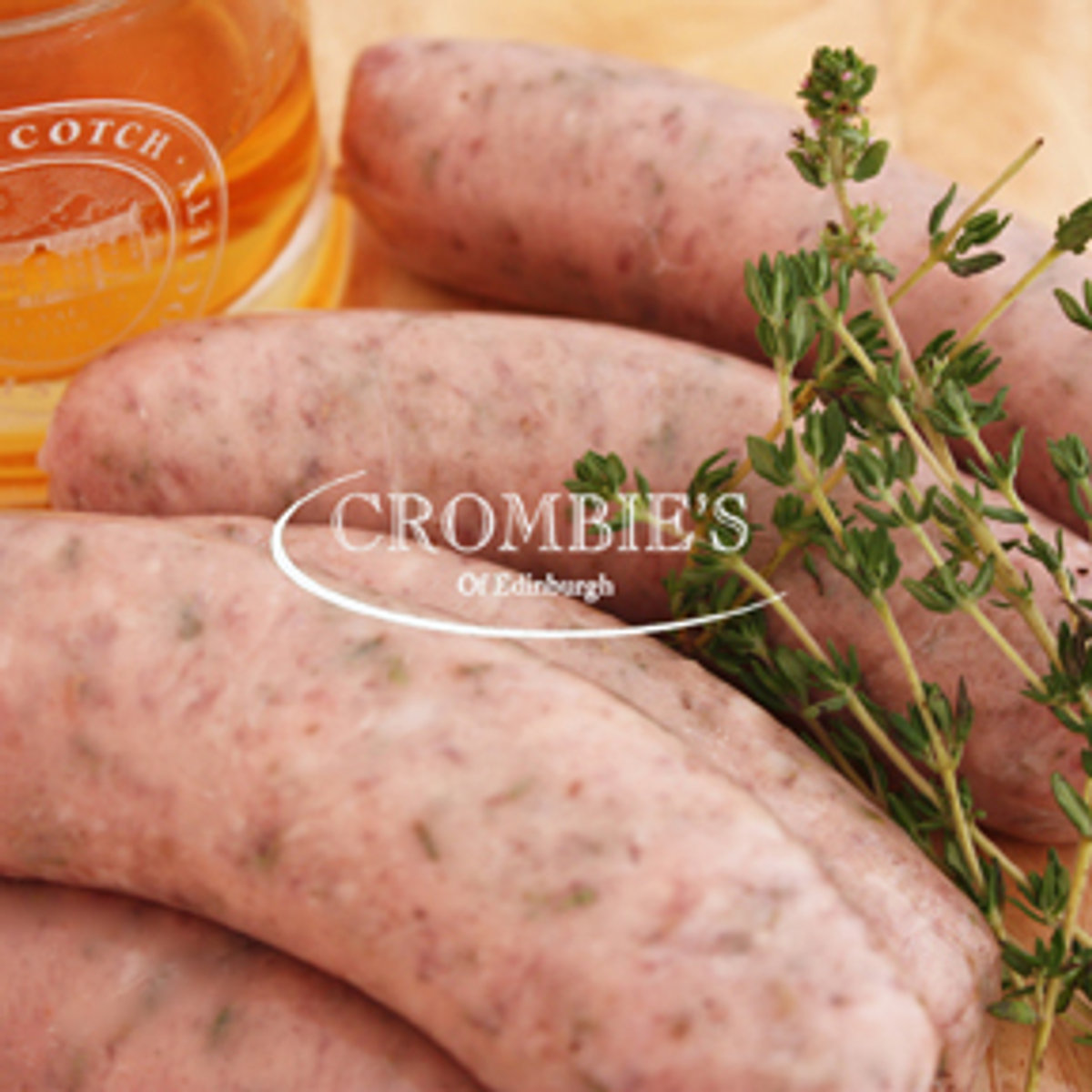 Fresh sausages with sprigs of thyme